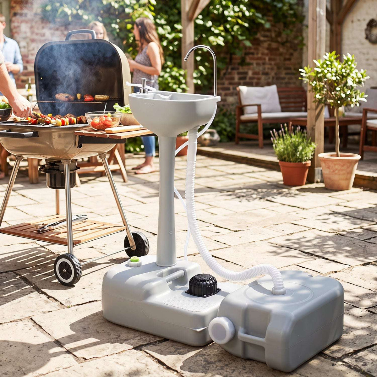 Portable camping sink unit with white basin, grey tank, and wheels