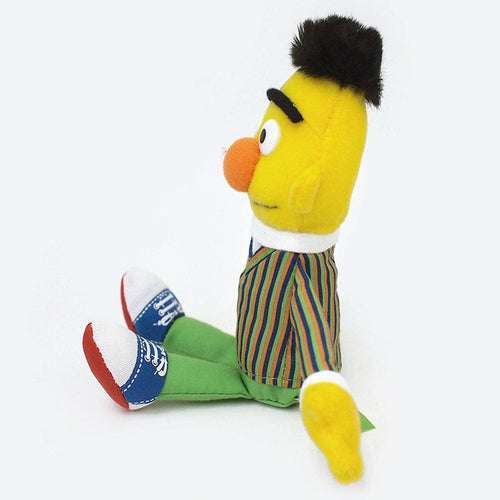 Bert plush in side profile, showing striped shirt and blue-and-white sneakers