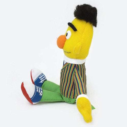 Bert plush in side profile, showing striped shirt and blue-and-white sneakers